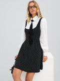 Step into style with this playful black and white striped A-line dress, perfect for fall and winter. Featuring charming puff lantern sleeves and a delicate tie collar, it adds a fun twist to your seasonal wardrobe. The flattering silhouette moves with you, making it ideal for cozy days and festive nights alike.