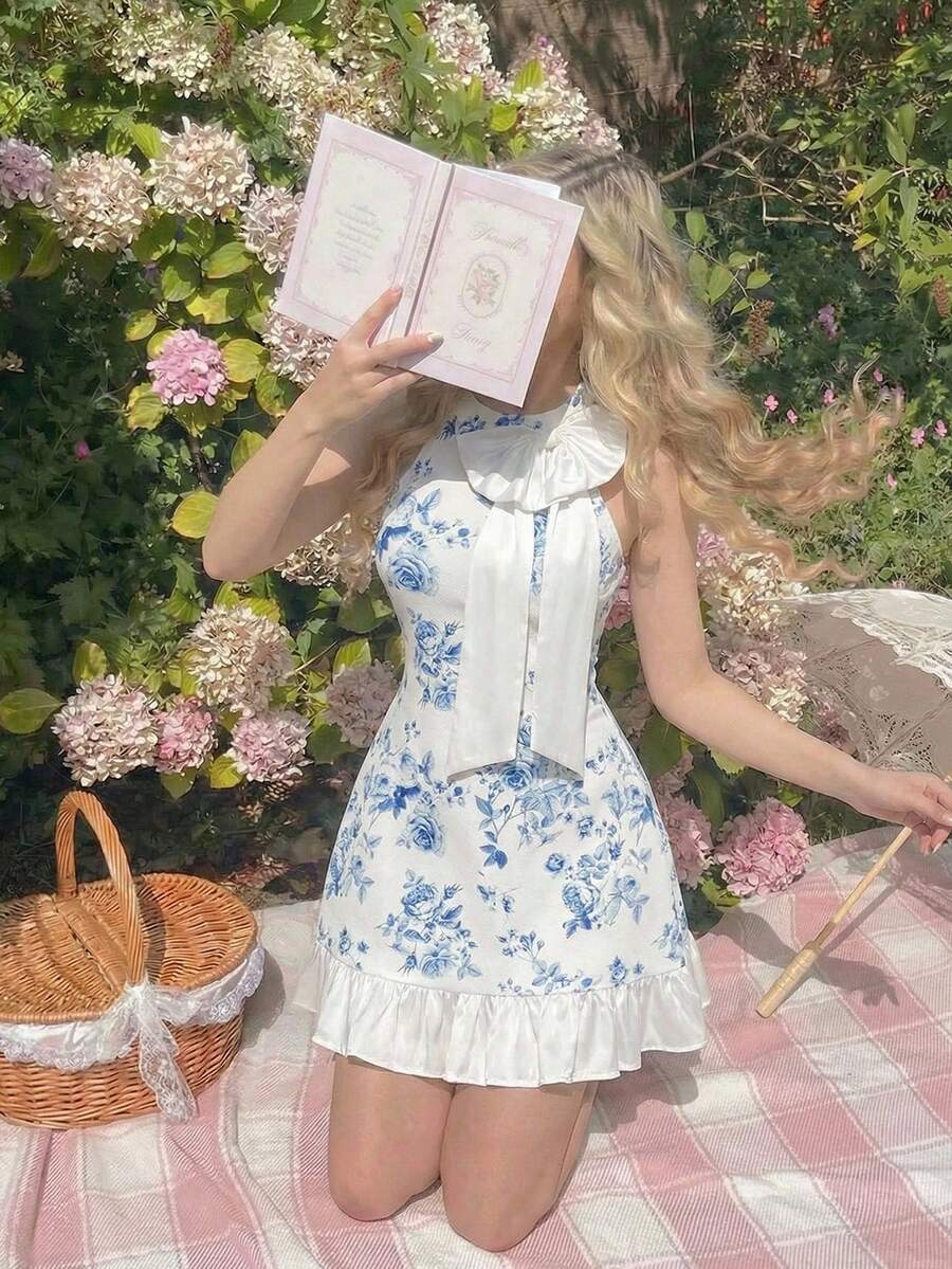 This refined blue and white floral mini dress combines timeless elegance with contemporary style, making it an ideal choice for spring and summer adventures. The distinctive bow collar detail adds sophistication and visual interest, while the botanical print brings fresh, seasonal appeal. Designed with versatility in mind, this piece works beautifully for resort wear, casual outings, or evening occasions. The mini length offers a modern silhouette that flatters various body types, ensuring you look and feel