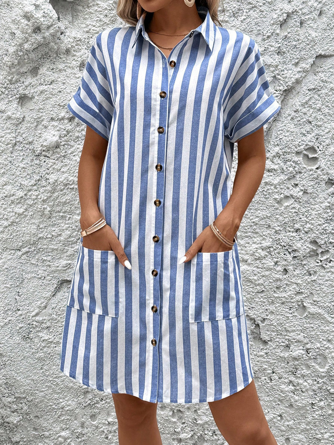 Turn heads with our Chic Blue and White Stripe Shirt Dress! Made from sustainable cotton, this fashionable dress not only looks great but also helps the environment. Perfect for any occasion, show off your unique style with this must-have dress. (Eco-friendly never looked so good!)