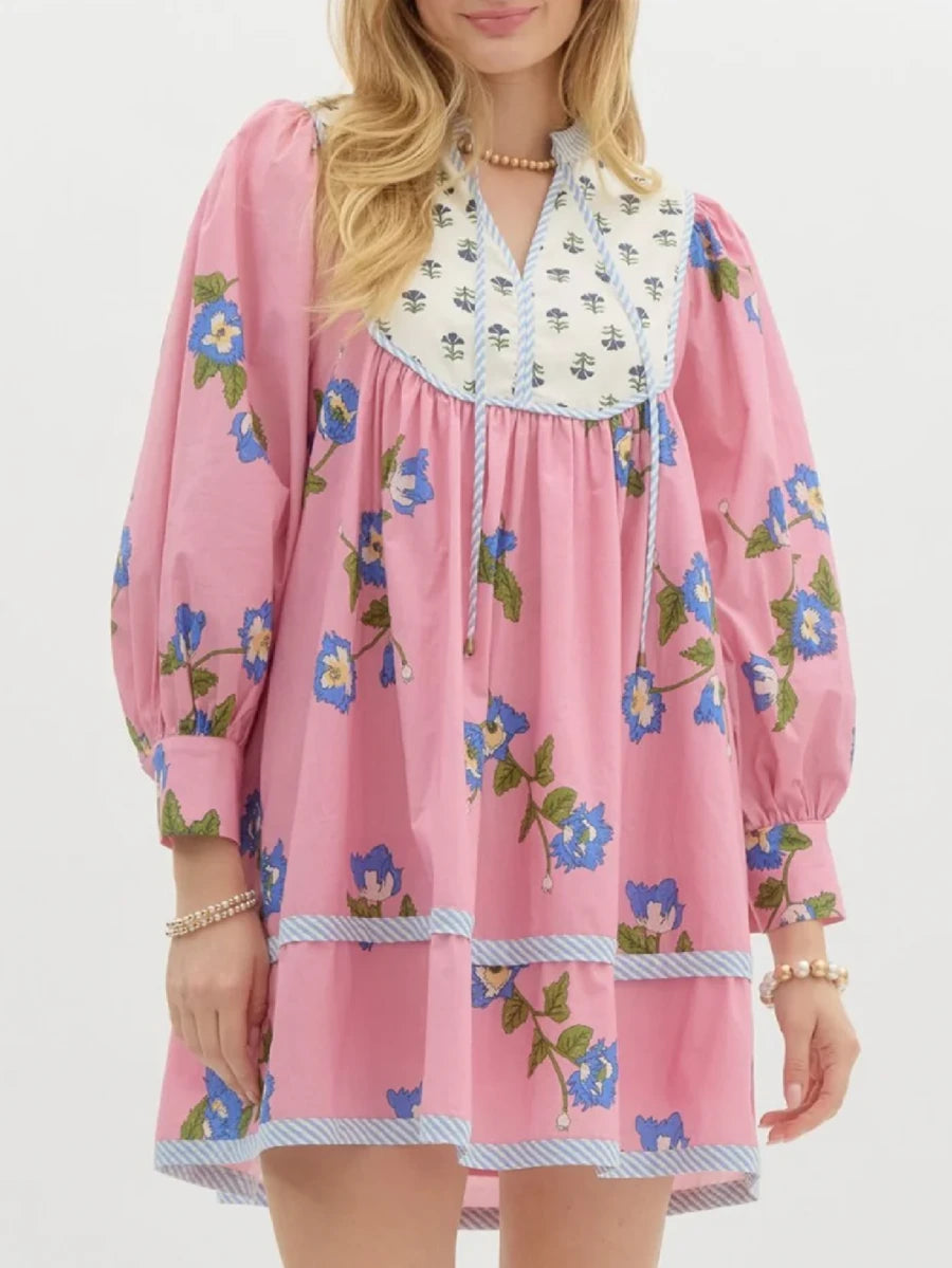 Embrace effortless bohemian style with this charming floral mini dress. Featuring a flattering V-neckline, romantic puff sleeves, and an A-line silhouette, this versatile piece transitions seamlessly from garden gatherings to casual street wear. The loose fit and medium stretch fabric ensure all-day comfort, while the delicate floral print adds a touch of whimsy. Perfect for spring and summer adventures, this dress pairs beautifully with sandals or sneakers for an understated, chic look that celebrates your