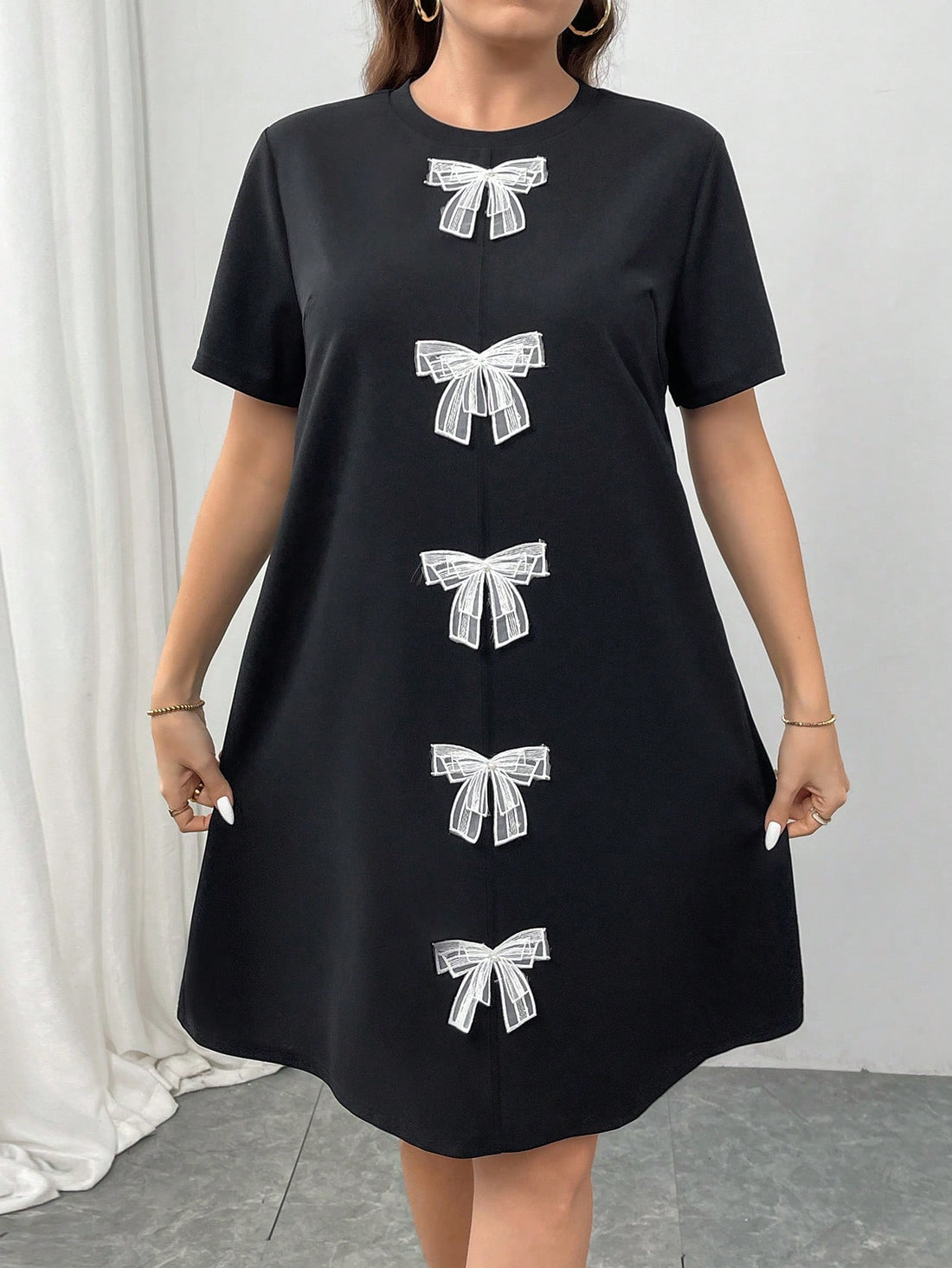 Redefine elegance with this playful and chic short sleeve dress. Featuring a unique bow accent and knitted fabric, this dress is perfect for adding a touch of charm to any look. Comfortable yet stylish, this dress is sure to become a staple in your wardrobe.