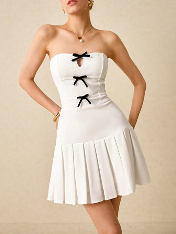Get ready to turn heads at any special occasion with our Chic Bow-Embellished Pleated Tube Mini Dress! Featuring a stunning bow detail and elegant pleats, this dress is the perfect choice for weddings and other special events. You'll feel confident and stylish all day (and night) long.