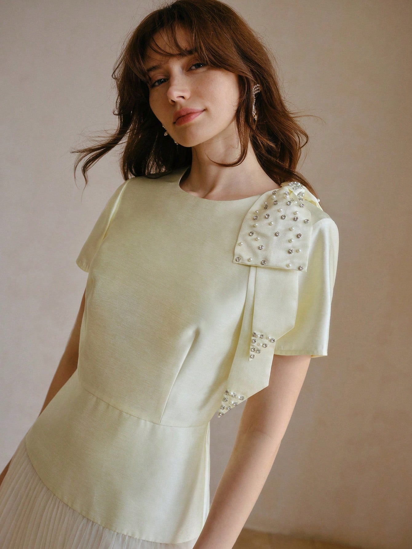 Step into the spotlight with this playful dress featuring a chic bow detail and contrasting mesh that adds a flirty twist. The pleated design flows gracefully, making every move effortlessly elegant. Perfect for turning heads and embracing your fun, fashionable side!