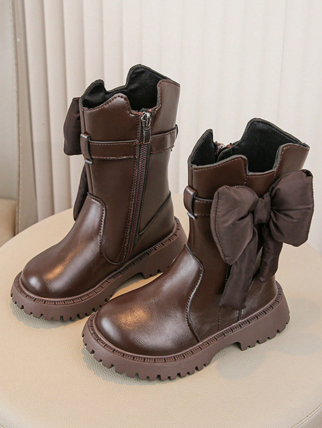 Elevate your little girl's winter wardrobe with our Chic Bowknot Ankle Boots. Designed with a stylish bowknot detail and a thick sole for durability and warmth. These boots will keep her feet comfortable and fashionable during the colder months. A must-have addition to any winter outfit!