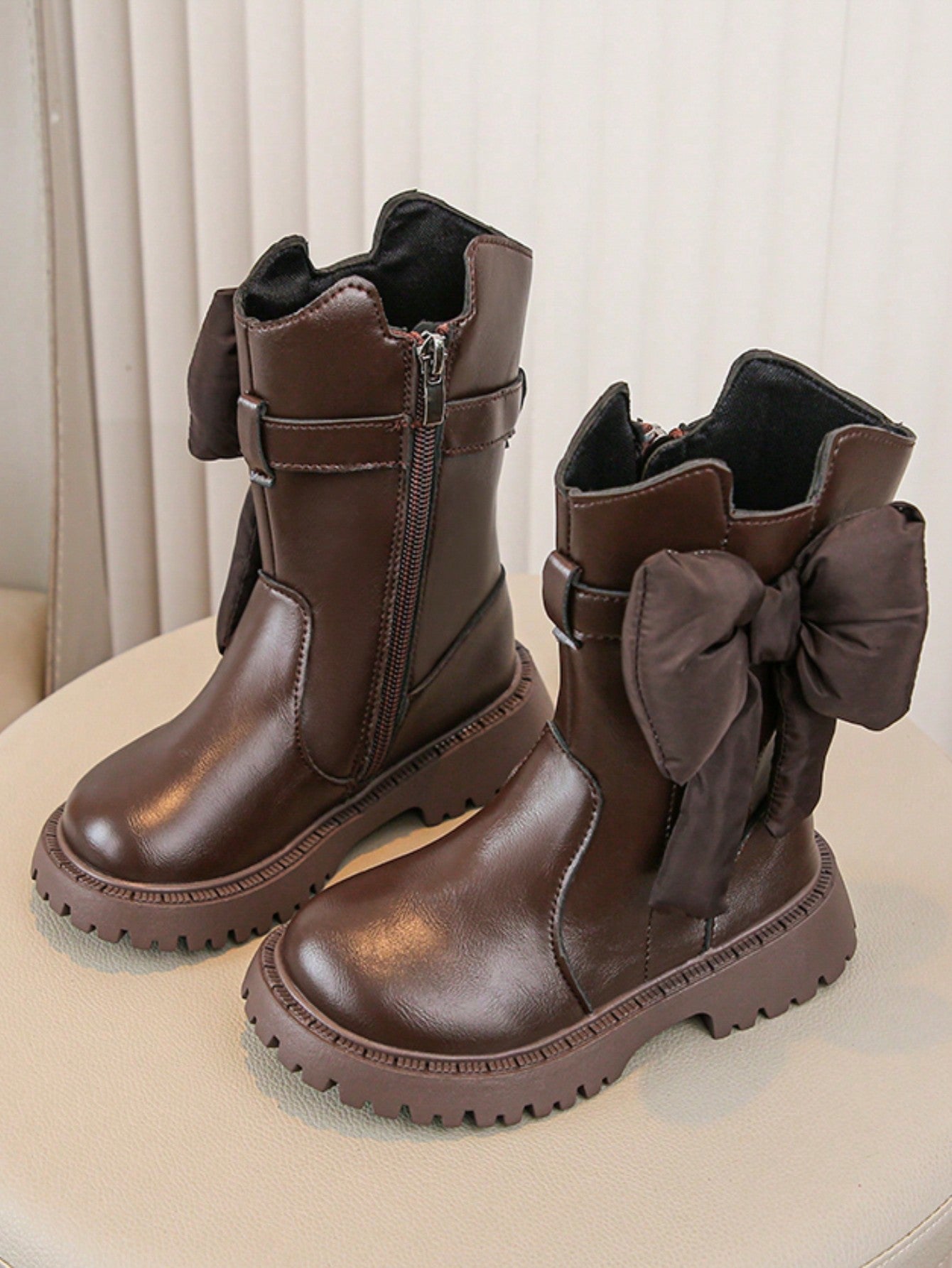 Elevate your little girl's winter wardrobe with our Chic Bowknot Ankle Boots. Designed with a stylish bowknot detail and a thick sole for durability and warmth. These boots will keep her feet comfortable and fashionable during the colder months. A must-have addition to any winter outfit!