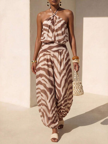 Front courtyard view of brown striped halter jumpsuit with twisted neckline and harem legs