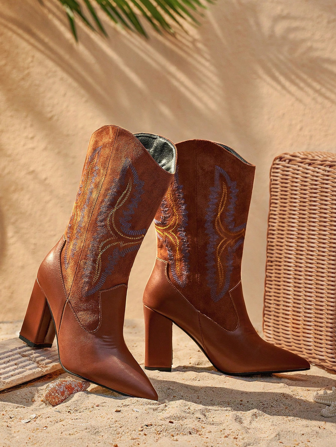 Step into style with these chic Western boots! Crafted from faux suede, these boots feature a unique color block design with gorgeous leaf embroidery. The block heels provide comfort and height for a bold, fashionable look. Perfect for the woman looking to add some flair to her wardrobe!