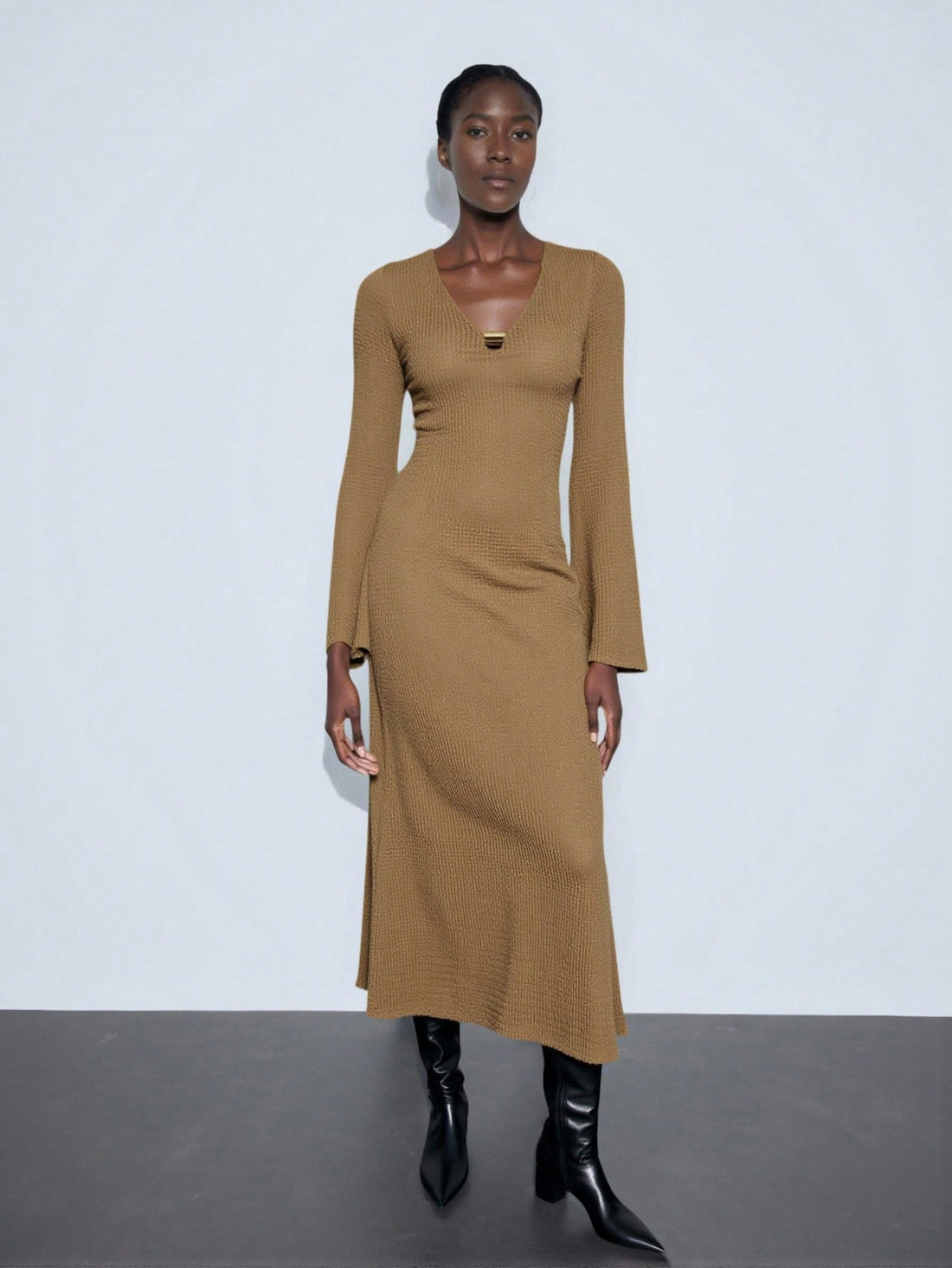 Step into the spotlight with this chic brown leather buckle dress, crafted to catch every eye. Featuring a flattering V-neck and playful pleats, it’s your go-to for New Year’s sparkle or Saudi National Day festivities. Short and stylish, it blends edgy leather with feminine flair—perfect for dancing the night away and making unforgettable memories.