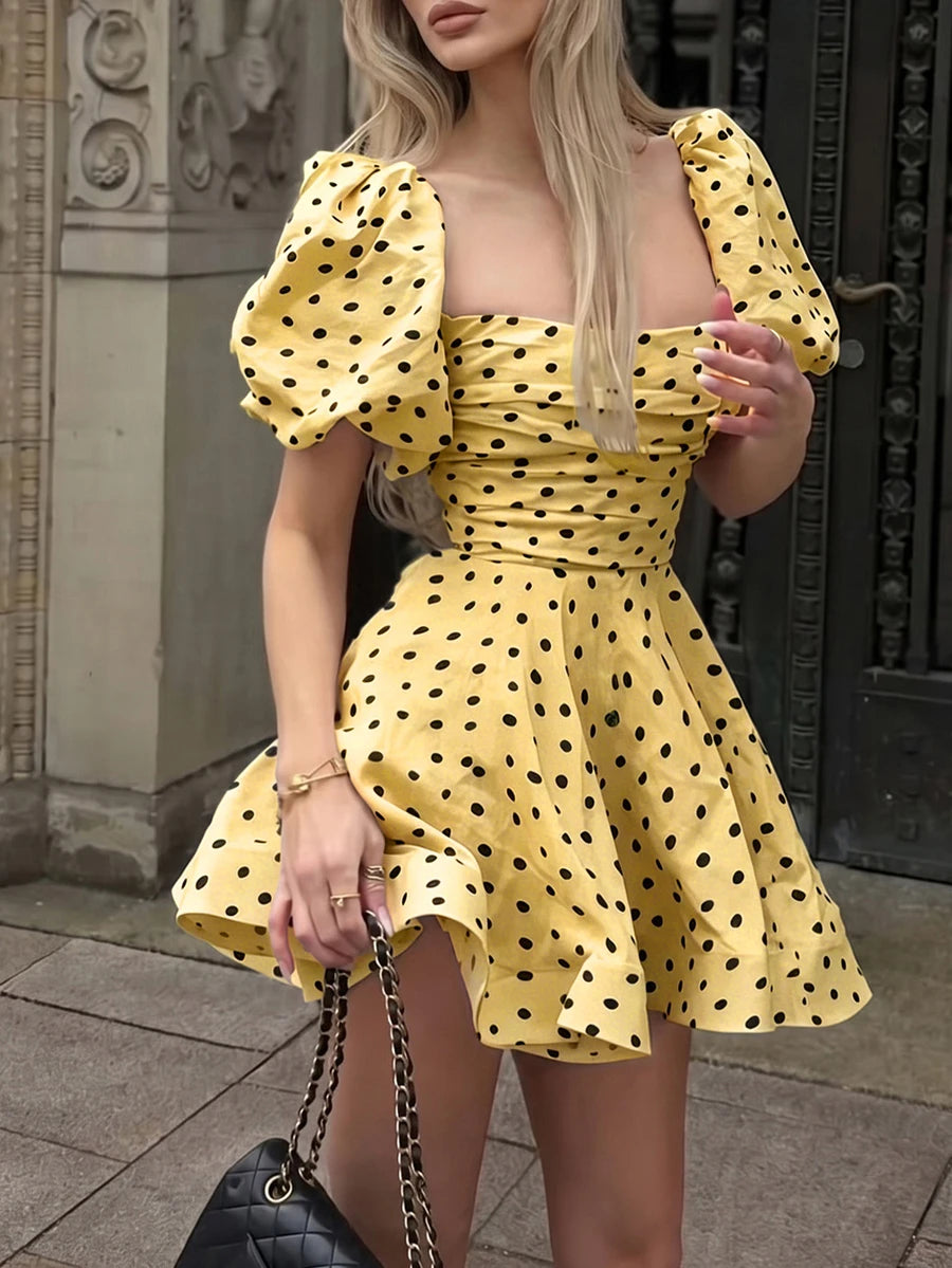 Yellow polka dot puff sleeve mini dress with black bag