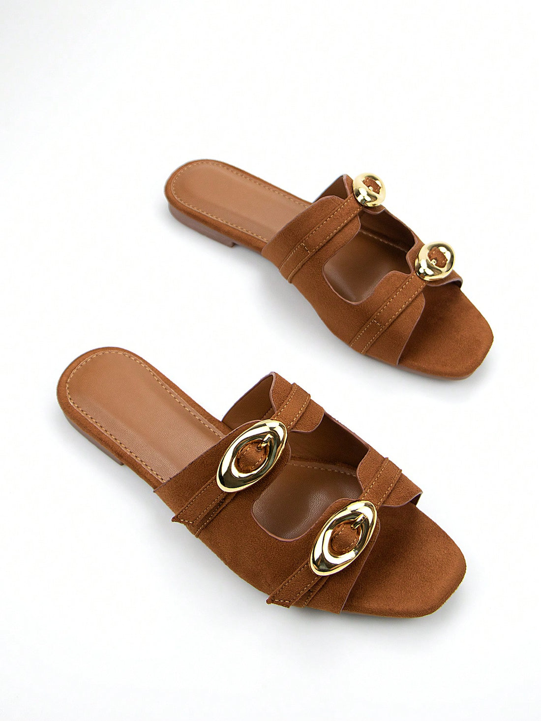 Slip into style with our Chic Brown Suede Square Toe Flat Mules. Featuring an adjustable strap and gold buckle, these versatile shoes are perfect for everyday wear. Make a statement with your feet and step into comfort and fashion.