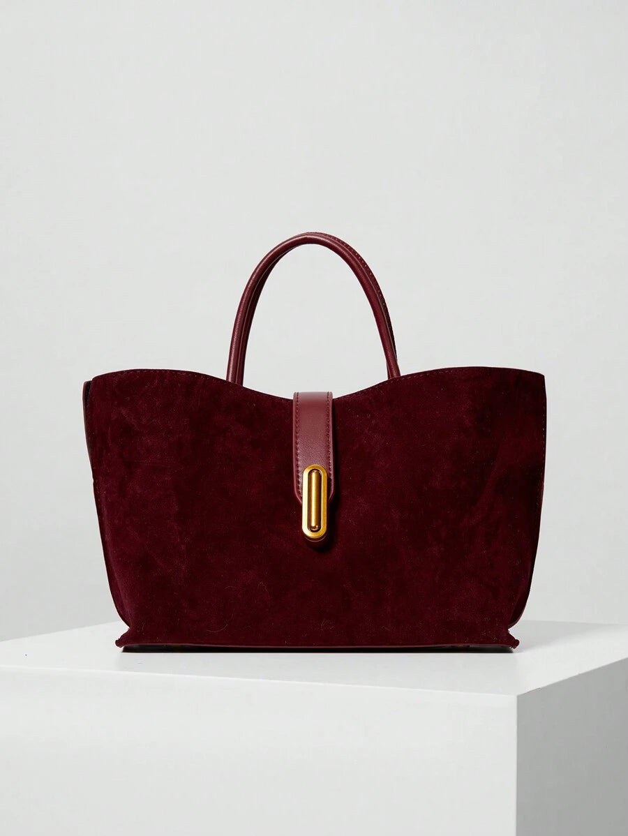 Elevate your everyday style with this sophisticated burgundy faux suede tote. Featuring a luxurious textured finish and eye-catching colorblock design, it's the perfect companion for office days, weekend shopping, or travel adventures. The detachable adjustable strap offers versatile carrying options, while the secure turn-lock closure keeps your essentials safe. Medium-sized and crafted from durable polyurethane, this casual yet polished bag transitions seamlessly from autumn through winter. Complete with 