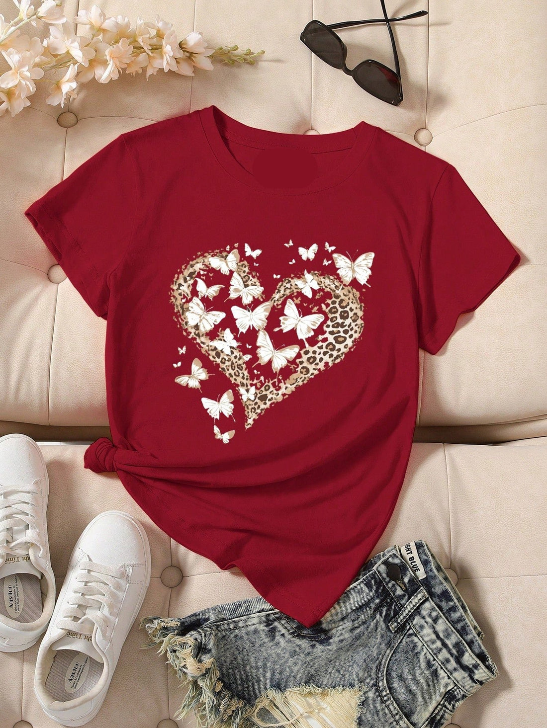 Embrace chic vibes with this trendy Leopard & Butterfly Print T-Shirt. The round neck design adds a touch of casual elegance, perfect for a day out or a cozy night in. With its unique print, you'll stand out in style while feeling comfortable and confident.