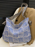 Expertly designed for daily use, the Chic Checkered Striped Geometric Shoulder Tote is a stylish and practical addition to any wardrobe. With a trendy checkered and striped geometric print, this tote is perfect for adding a touch of sophistication to any outfit. Its spacious interior and durable design make it ideal for all your daily essentials. Upgrade your daily style with this must-have tote.