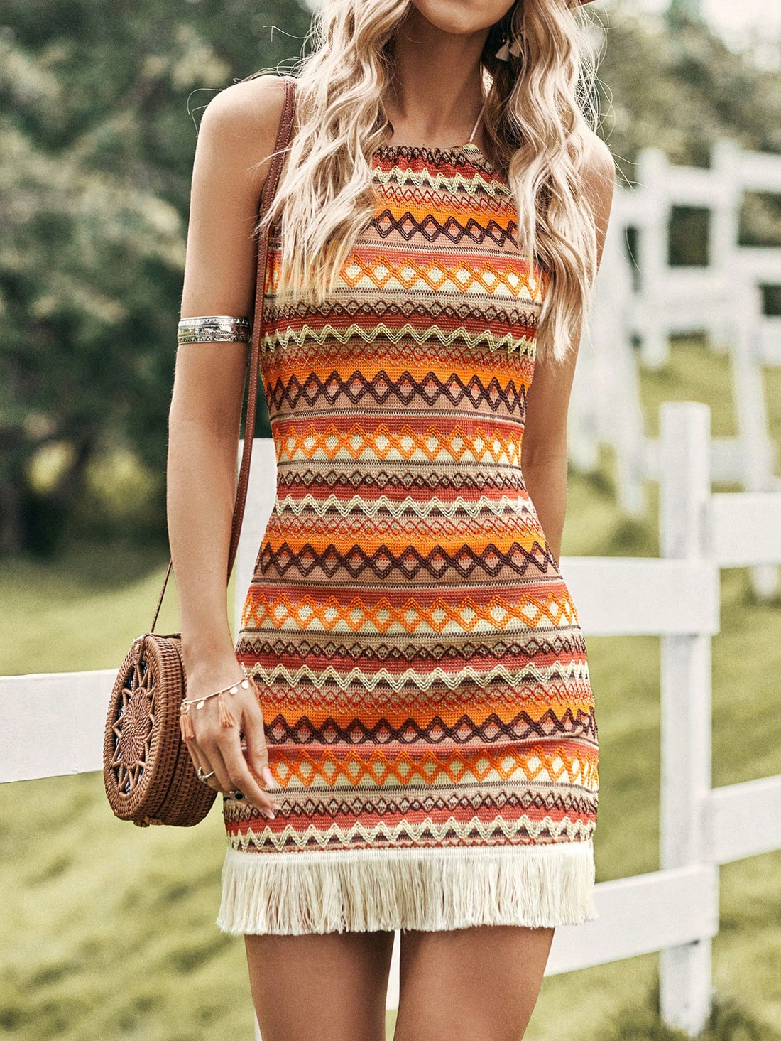 Elevate your spring concert style with our Chic Chevron Print Bodycon Dress. The trendy chevron print and fringe hem add a touch of fun, while the bodycon silhouette flatters your figure. Perfect for dancing the night away in style.