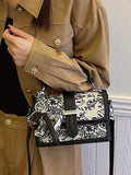 Black and white floral structured handbag with top handle