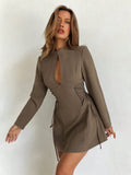 Elevate your seasonal wardrobe with this charming coffee brown mini dress that's equal parts cozy and chic. The statement puff sleeves add a playful touch while the criss-cross tie detail at the waist creates flattering definition. Perfect for autumn and winter gatherings, this versatile piece transitions effortlessly from casual coffee dates to evening outings. The rich brown tone pairs beautifully with boots, sneakers, or heels, making it a go-to favorite for any occasion.