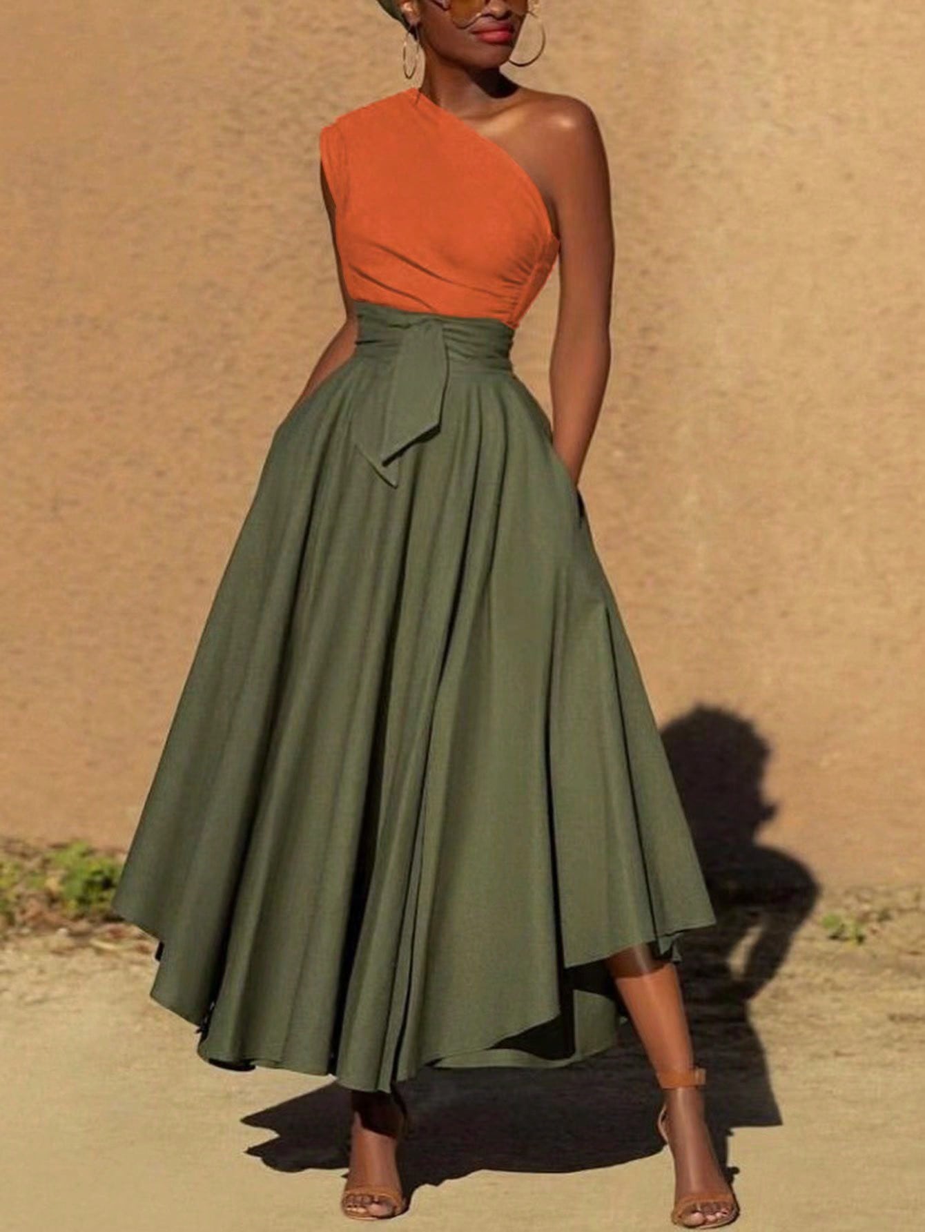 Get ready for a chic and colorful beach vacation with our maxi dress! Featuring a trendy asymmetrical neckline, front slit and knot detail, this dress will make you stand out in the sun. Perfect for a fun and stylish getaway, don't forget to pack this must-have dress!