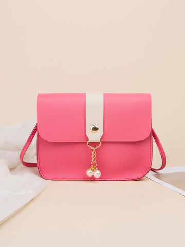 Upgrade your on-the-go style with our chic color block crossbody bag. With a stylish pearl pendant and a mini size, this bag is perfect for any occasion. Stay organized and trendy with this must-have accessory.