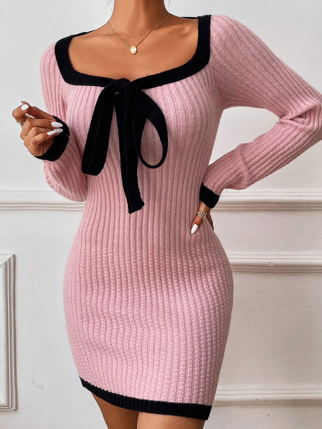 Effortlessly elevate your style with our Chic Contrast Trim Knot Front Sweater Dress. The unique knot front design adds a touch of sophistication and the contrast trim adds visual interest. Perfect for any occasion, this dress is a must-have for your wardrobe.