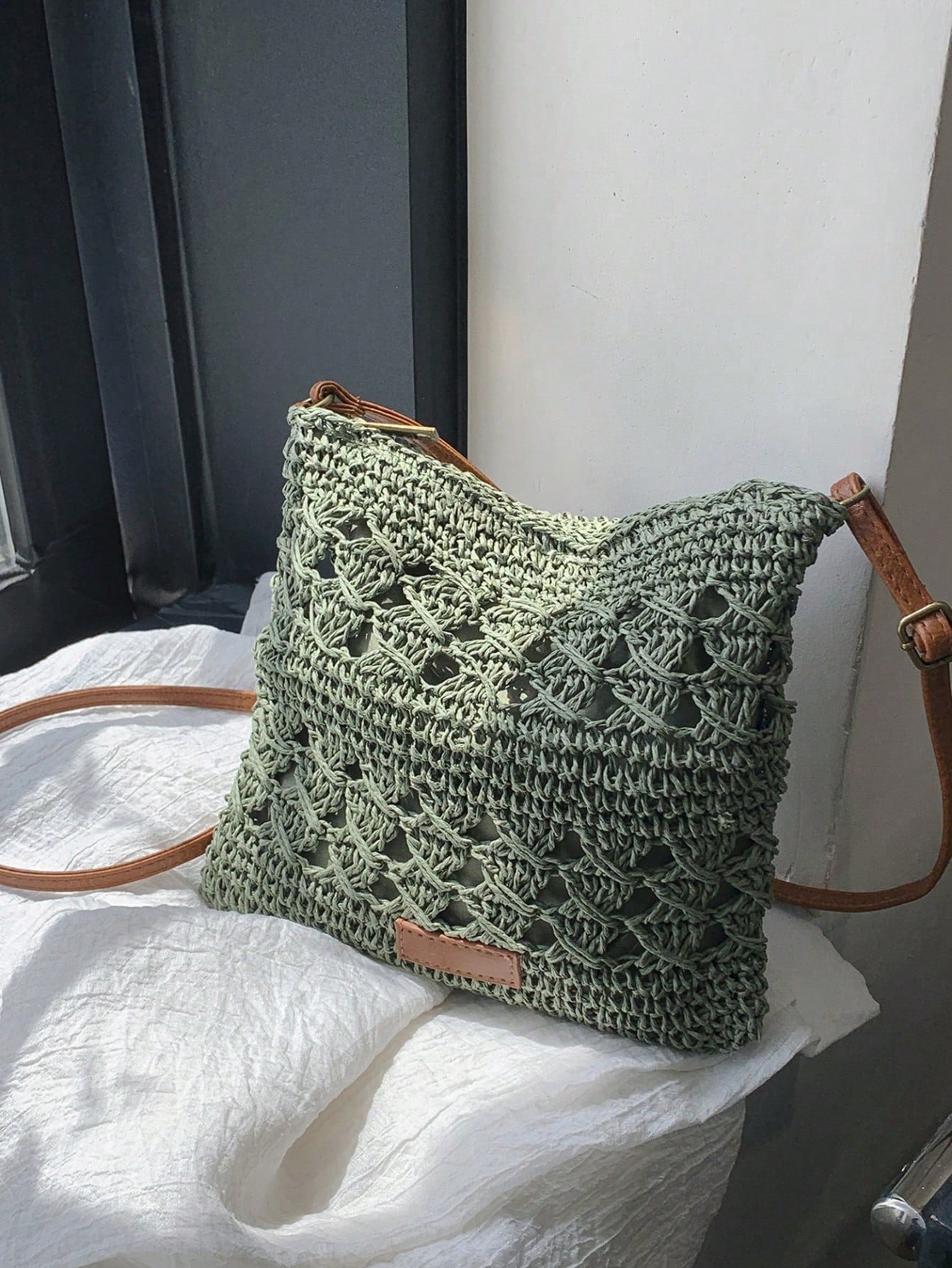 Expertly crafted with a chic crochet design, this crossbody bag is the perfect gift for anyone who loves effortless style. Keep your essentials organized while on-the-go in this stylish and practical bag. Its versatility makes it the ideal accessory for any leisurely outing.