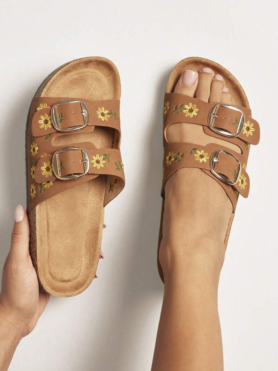Step into effortless style with these charming Daisy Stitch Cork Slides. Designed for all-day comfort, the dual buckle footbed system provides secure support and a customizable fit. The cork construction offers natural cushioning and breathability, perfect for warm weather wear. Whether you're heading to the beach, running errands, or relaxing at home, these slides deliver a perfect blend of chic design and practical comfort. 