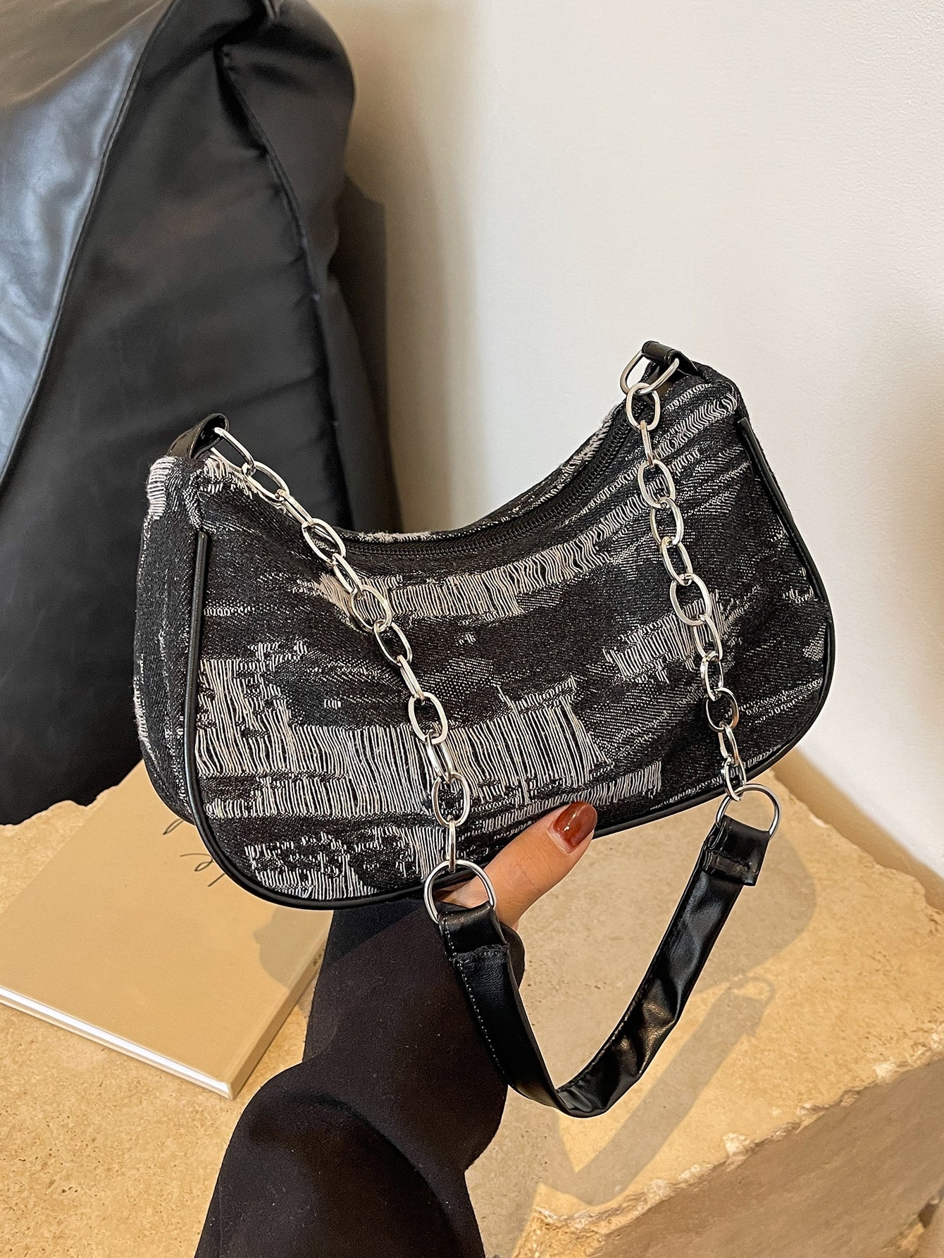 This chic denim chain shoulder bag effortlessly adds style to any occasion. With its versatile design, it's perfect for any outfit. The chain strap adds a touch of sophistication, while the spacious interior offers plenty of room for all your essentials. Elevate your wardrobe with this must-have accessory.