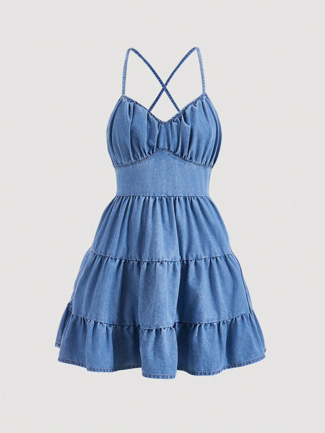 Get ready to delight in this chic and playful dress! Crafted with soft denim and featuring a unique pleated back and cross-strap design, this dress is sure to turn heads. Perfect for any occasion, from a casual day out to a special date night. Say hello to your new wardrobe staple!