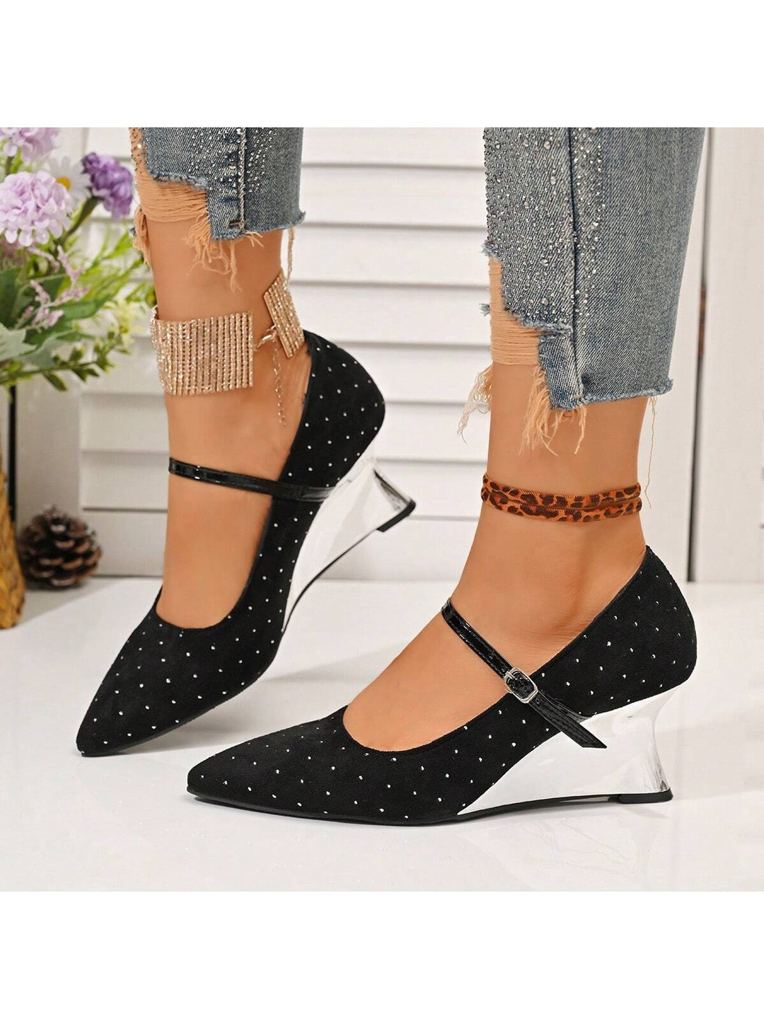 Introducing Chic Elegance: stylish, chic, and elegant. These women's black pointed toe wedge heels add a touch of sophistication to any outfit. With rivet detailing and an ankle strap, these heels are both trendy and comfortable. Elevate your look with Chic Elegance.