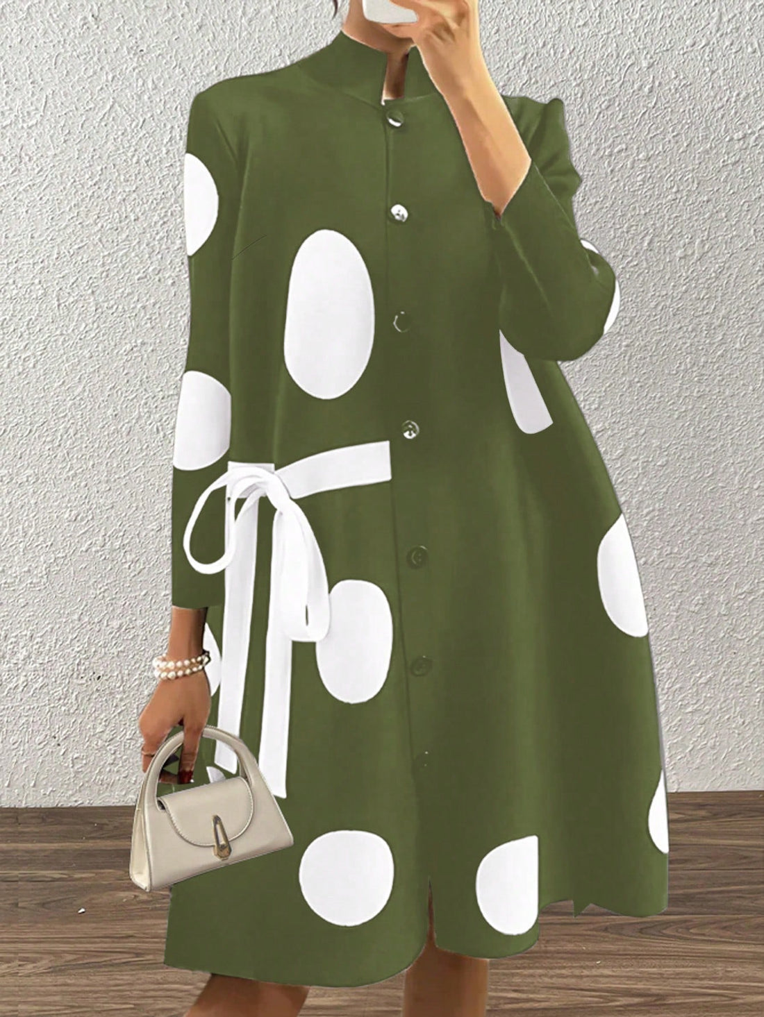 Introducing our Chic Elegance polka dot dress, designed for the fashion-forward women who loves to stand out! With its stand collar and tie closure, this dress exudes effortless elegance and offers a flattering fit. Perfect for any occasion, you'll feel chic and stylish in this one-of-a-kind dress.