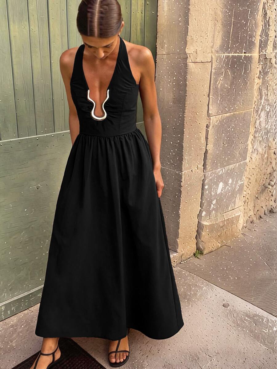 Front view of black halter neck backless A-line evening dress with gold accent