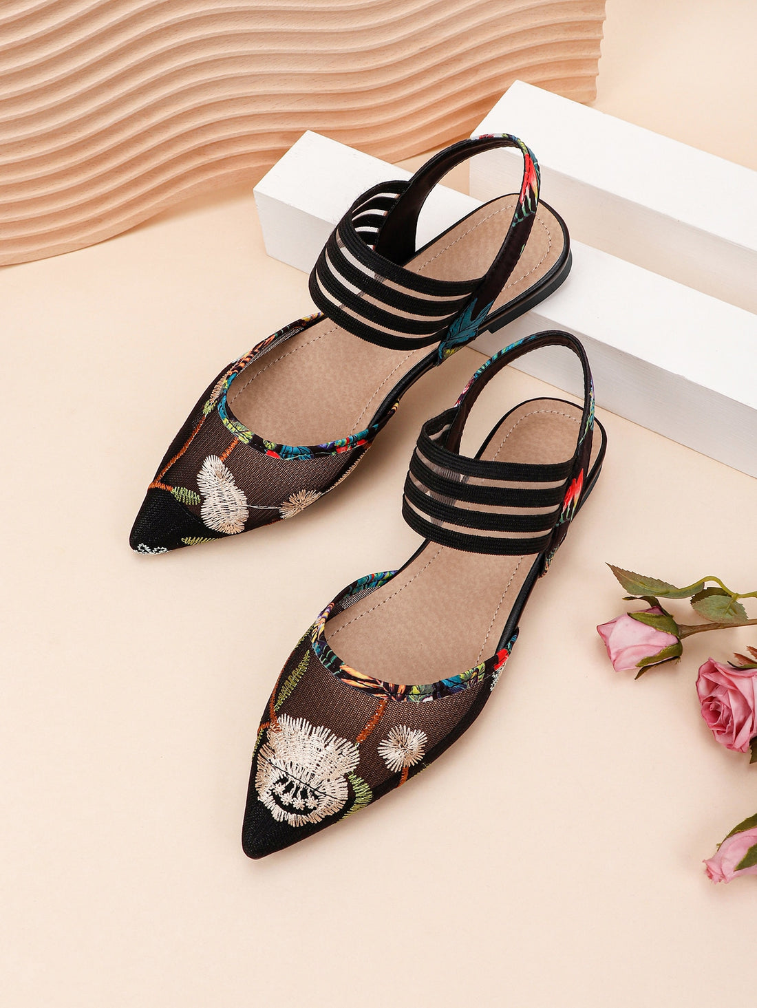 Make a statement with our Chic Embroidered Mesh Pointed-Toe Slip-On Flat Mules. These elegant shoes effortlessly combine fashion and comfort. The pointed-toe design elongates the leg while the slip-on style provides convenience. The mesh material adds a touch of sophistication, making it perfect for any occasion.