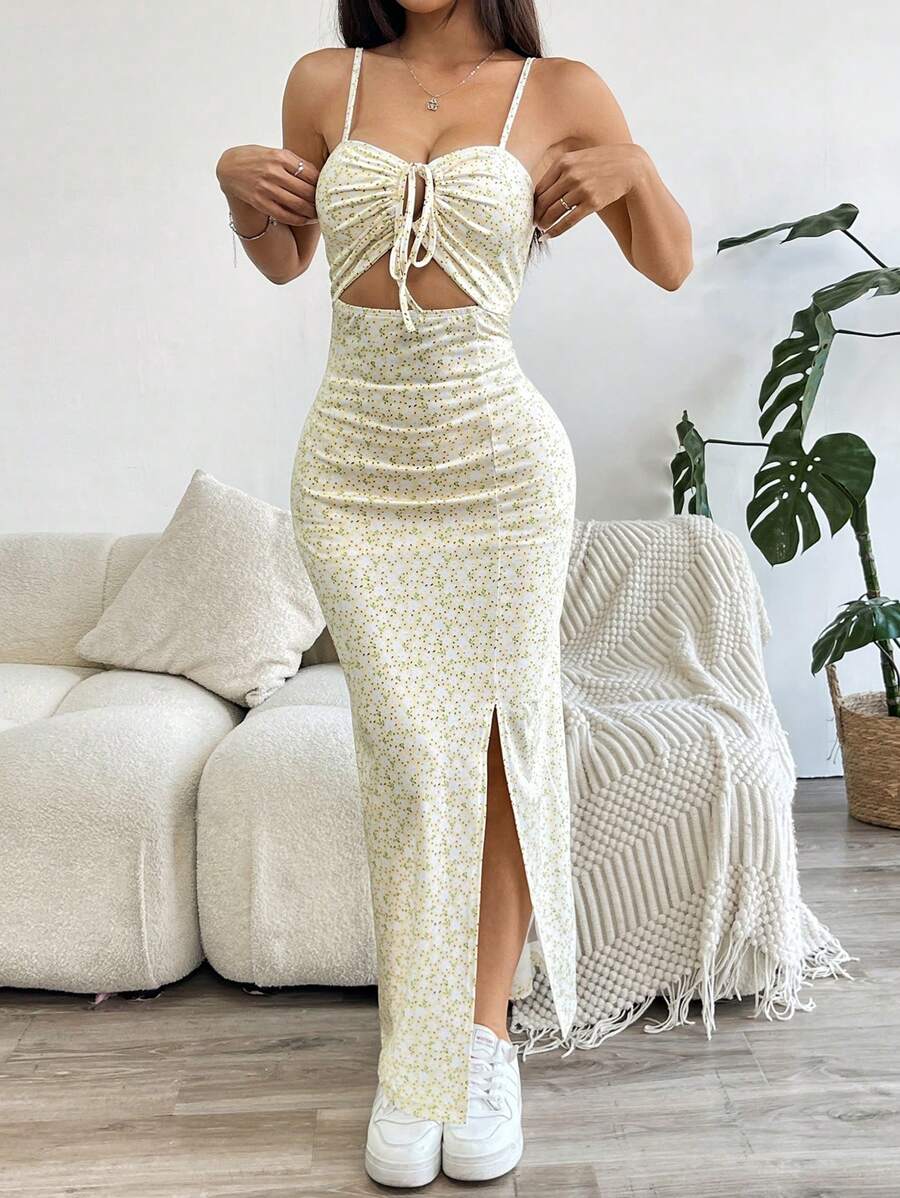 Effortlessly exude elegance in this chic floral camisole dress. Featuring a playful cutout and dramatic thigh slit, this dress is perfect for any occasion. With its unique design, you'll stand out and turn heads wherever you go. Who said elegance has to be boring?