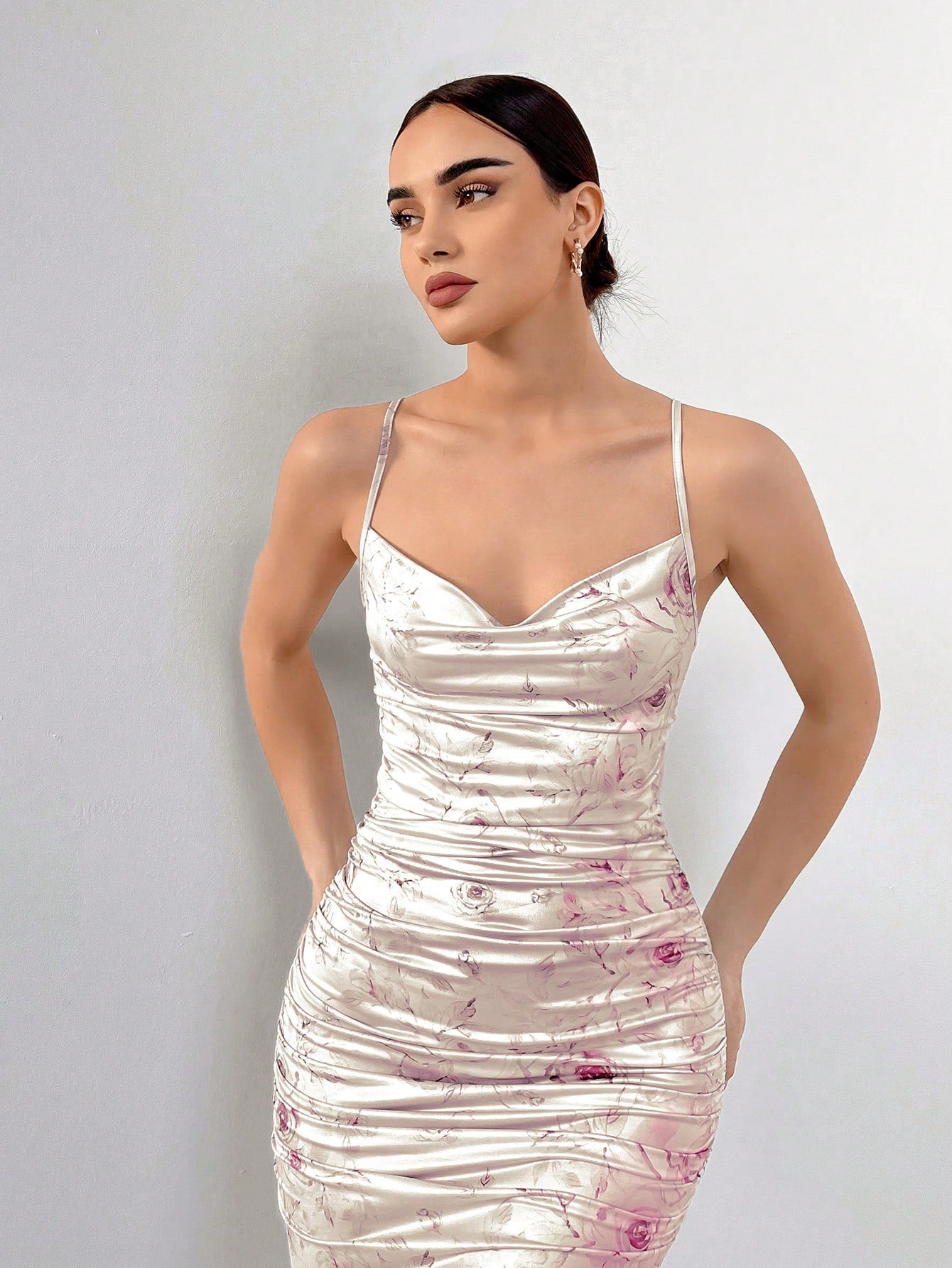 Stay cool and elegant this summer in our Chic Floral Draped Neck Cami Dress. With its effortless draped neckline and beautiful floral print, this dress is perfect for any summer occasion. Add a touch of elegance to your wardrobe and beat the heat in style.