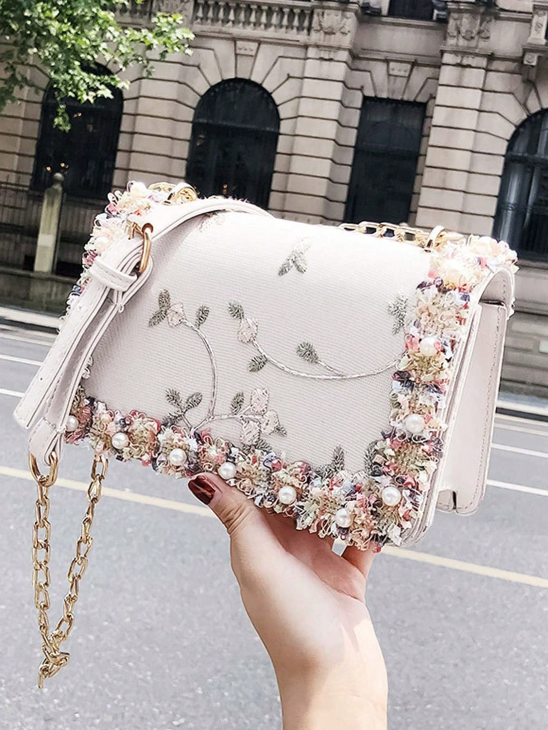 This elegant mini bag features chic floral embroidery and faux pearl accents for a sophisticated look. Perfect for any occasion, this square bag adds a touch of elegance to any outfit. Its compact size makes it a convenient accessory, while its unique design is sure to make a statement.