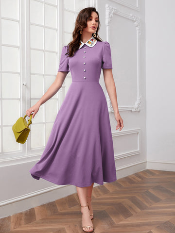 Add a touch of playful charm to your wardrobe with our Chic Floral Embroidery Contrast Collar Dress in Lilac Purple. The delicate embroidery and contrasting collar add a touch of quirkiness to this chic dress, perfect for any occasion. (Seriously, though, it's the cutest dress ever!)