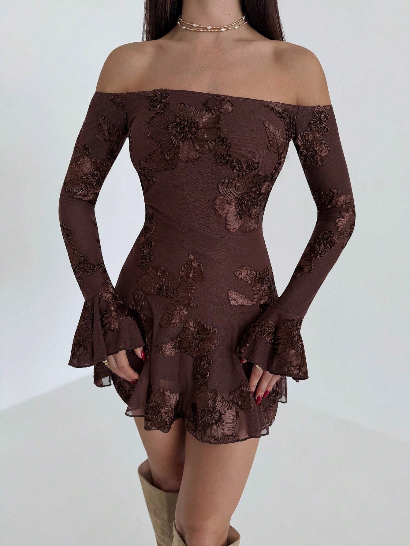 Embrace the season with this charming off-shoulder mini dress, where delicate floral embroidery meets effortless sophistication. The romantic neckline frames your shoulders beautifully while the intricate needlework adds a touch of artisanal flair. Perfect for transitioning from summer warmth into cooler autumn days, this piece strikes the ideal balance between playful and polished. Slip it on for brunch dates, casual gatherings, or whenever you want to feel undeniably chic without trying too hard.