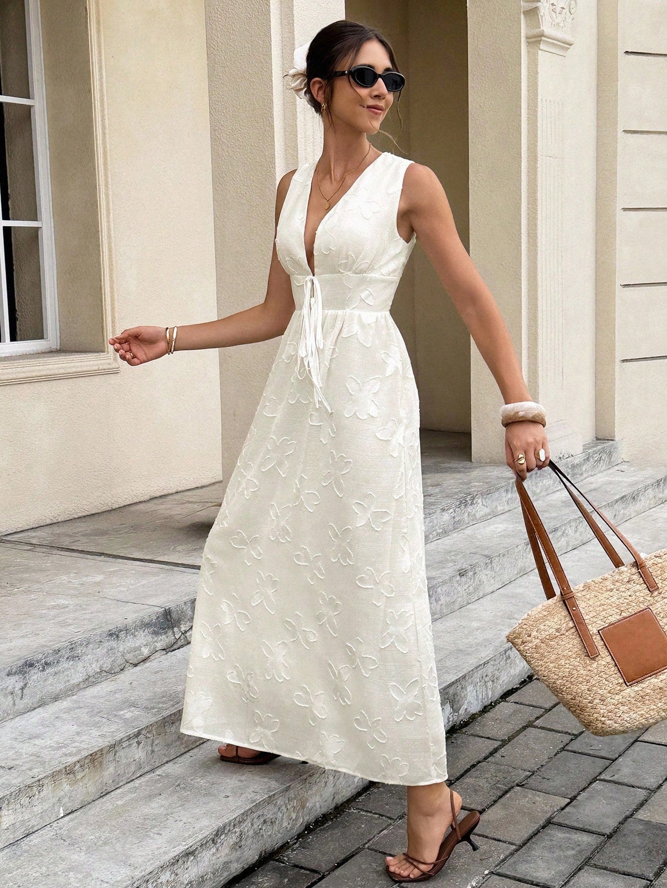 Step into effortless elegance with this chic floral jacquard dress. Featuring a deep V-neck and a flattering tie waist, its sleeveless design keeps things light and breezy. Perfect for turning heads with a playful touch of sophistication wherever you go.