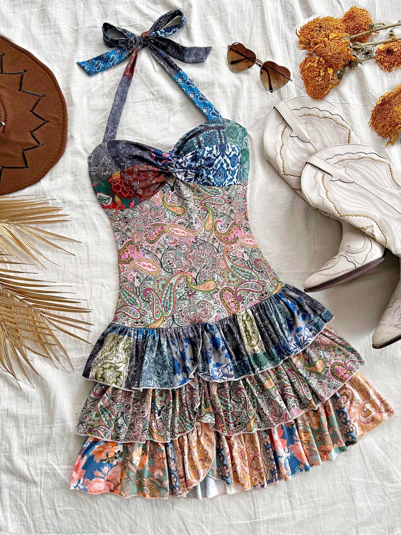 Elevate your vacation or date night look with our Chic Floral Pleated Mini Dress. The delicate bowknot detail adds a charming touch. Made with premium fabrics, this dress provides both comfort and style. Perfect for any occasion, this versatile dress is a must-have for any fashion-forward woman.