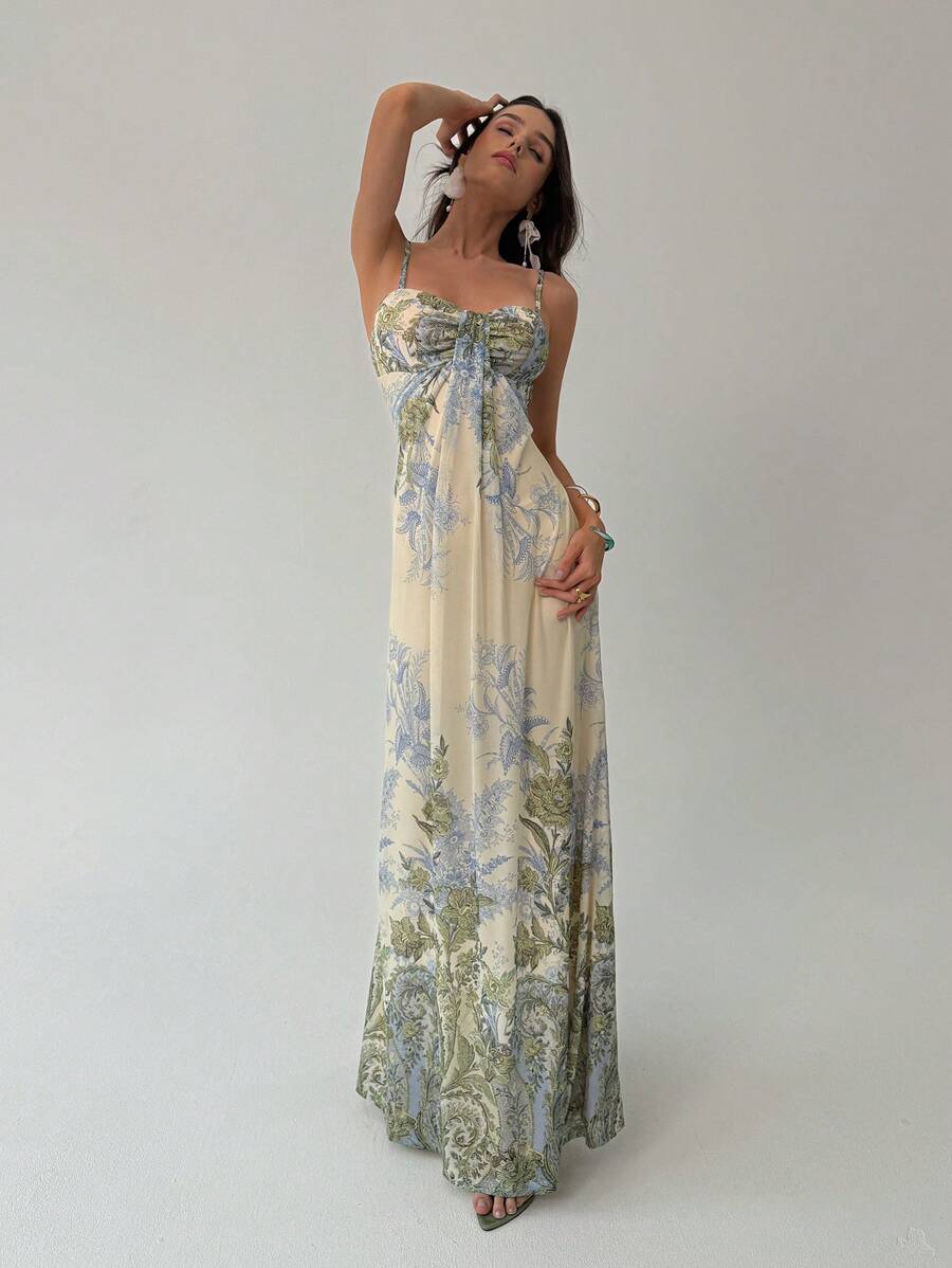 Model front view wearing cream floral toile maxi dress with thin straps and gathered knot bust