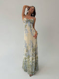 Model front view wearing cream floral toile maxi dress with thin straps and gathered knot bust