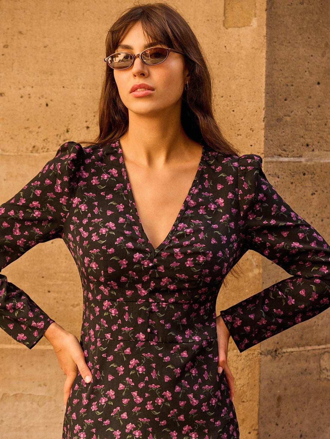 Bloom into autumn with this stunning floral midi dress that's equal parts sophisticated and fun. The deep V-neckline adds a touch of allure while the flowing long sleeves keep you cozy as temperatures drop. Perfect for brunch dates, casual outings, or those moments when you want to look effortlessly put-together without trying too hard. The midi length hits just right, giving you that sweet spot between playful and polished. Whether you're pairing it with sneakers for a laid-back vibe or dressing it up with