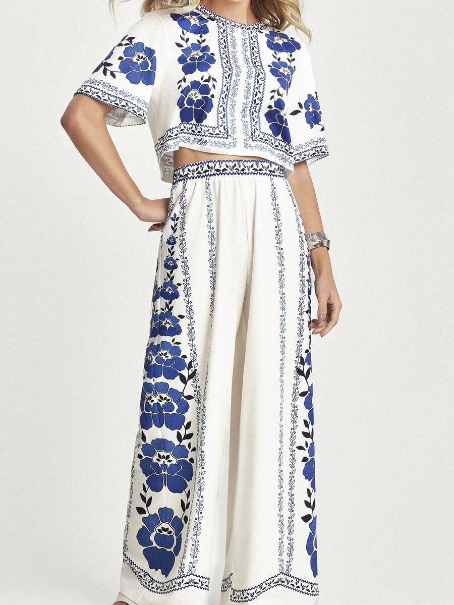 Effortlessly chic meets vacation-ready with this fabulous two-piece set! The floral print tee brings a pop of color and personality, while the wide-leg pants offer that coveted relaxed-yet-polished vibe. Whether you're strolling through a tropical destination or keeping it casual at home, this combo strikes the perfect balance between comfort and style. Mix, match, or wear together—either way, you'll look put-together without trying too hard. Your go-to outfit just got an upgrade!