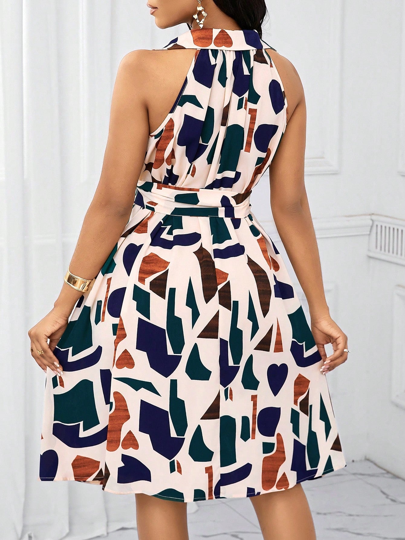 Step out in style this summer with our Chic Geometric Print Bow-Waist Dress. With a playful geometric print and a flattering bow-waist design, this dress effortlessly combines elegance with fun. Perfect for any summer occasion, this dress is sure to make you stand out in a crowd.