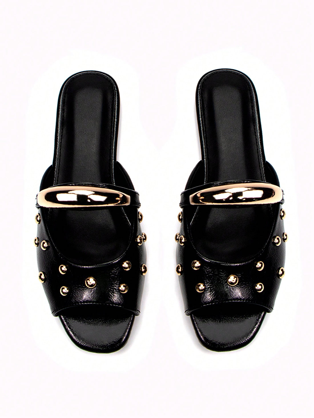 Elevate your everyday footwear with these sophisticated black patent mule slides, featuring a striking gold buckle accent that adds refined elegance to any casual ensemble. The sleek patent leather finish delivers a polished look while maintaining the comfort of a slip-on design, making them ideal for effortless transitions from home to errands. The flat sole provides all-day wearability without sacrificing style, while the minimalist silhouette pairs seamlessly with jeans, dresses, or relaxed separates. Pe