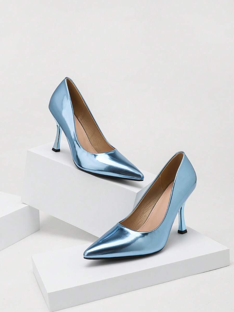 Front three-quarter view of metallic blue pointed-toe stiletto pumps