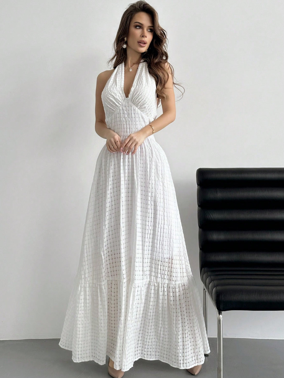 Turn heads this season in our stunning halter neck plaid dress, where timeless pattern meets modern flair. The flattering halter design frames your shoulders beautifully, while the playful ruffle hemline adds movement and charm to every step. Crafted in crisp white, this versatile piece transitions effortlessly from graduation celebrations to summer dates and beyond. Whether you're dressing up for a special occasion or elevating your everyday style, this dress delivers that perfect balance of sophistication