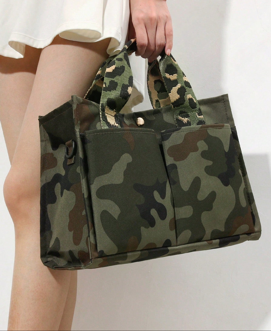 Carry your essentials in style with this eye-catching handmade tote bag featuring a retro camouflage green design. Perfect for commuters and students alike, the spacious interior keeps your daily must-haves organized and accessible. The durable construction and chic aesthetic make it an ideal companion for school runs, office days, or weekend adventures. Whether you're heading to class or catching the train, this versatile bag blends vintage vibes with modern practicality—because looking good shouldn't mean