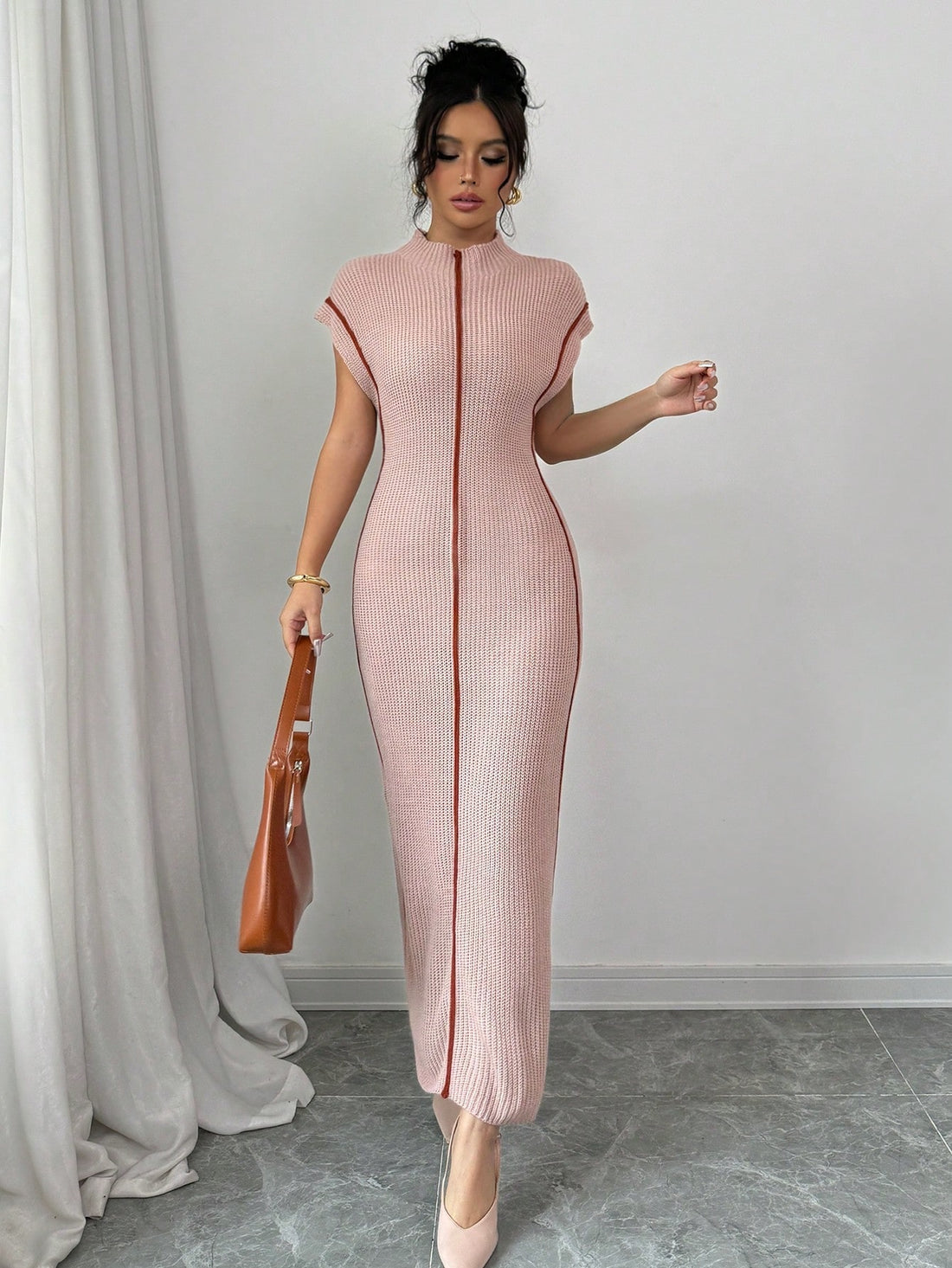 Stay chic and cozy this fall and winter with our High-Neck Sleeveless Sweater Dress. Effortlessly slimming and stylish, it's the perfect addition to your wardrobe. Keep warm without sacrificing fashion in this long sweater dress.