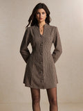 Front view of khaki houndstooth mini dress with long sleeves and covered buttons for workwear