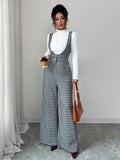 Elevate your fall wardrobe with this chic houndstooth jumpsuit set that screams effortless sophistication. The classic wide-leg silhouette pairs perfectly with a cozy turtleneck for those crisp autumn days when you want to look put-together without trying too hard. The timeless houndstooth pattern adds a playful twist to your everyday style, making it ideal for everything from casual outings to weekend brunches. Comfortable, versatile, and undeniably stylish—this is the one-piece wonder that'll become your 